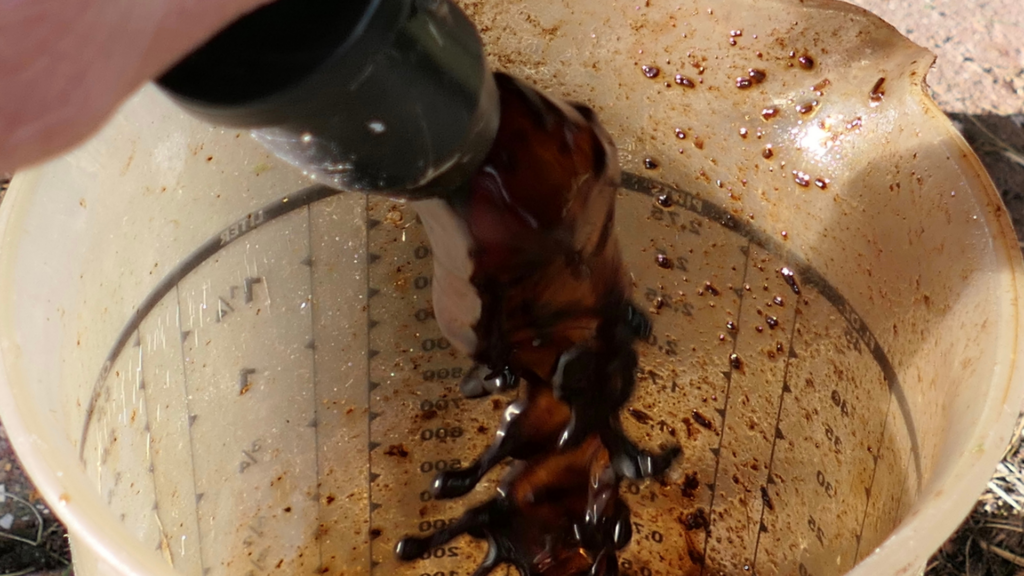 A close-up of dark, nutrient-rich worm tea being poured into a clear measuring container. The image highlights the process of brewing worm tea, a liquid fertilizer made from vermicompost, showcasing its use as an eco-friendly solution for enriching plants and soil.






